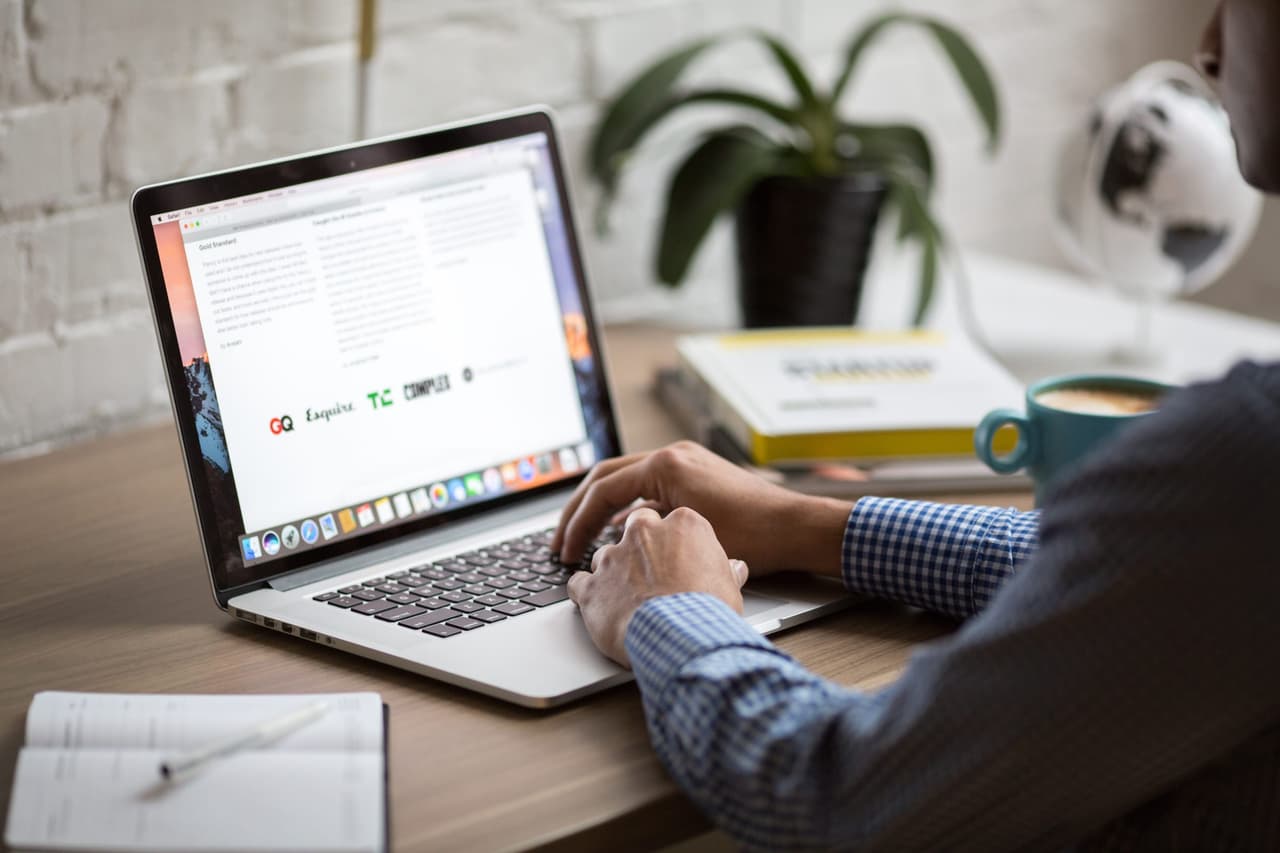 Person working on a laptop at a desk